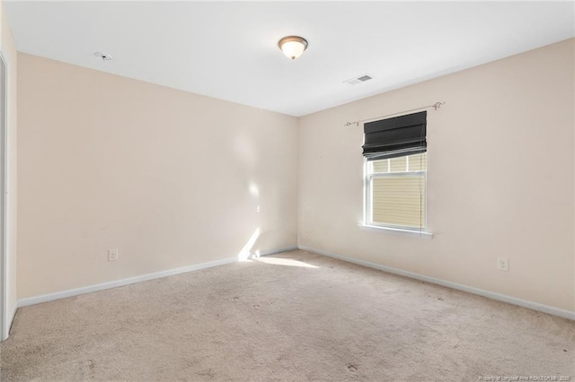 unfurnished room featuring light carpet, visible vents, and baseboards