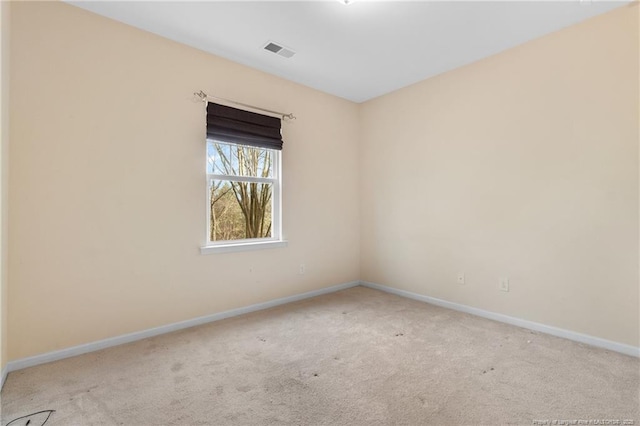 unfurnished room with light colored carpet, visible vents, and baseboards