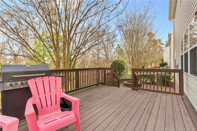 wooden deck featuring a grill