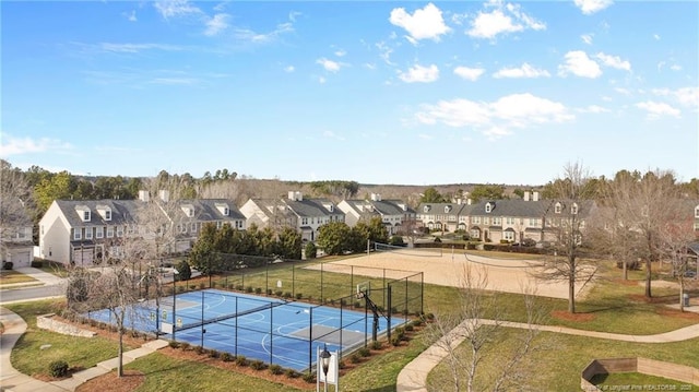 view of pool with a tennis court, a lawn, fence, and a residential view