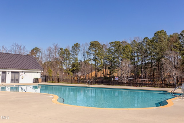 community pool featuring a patio area and fence