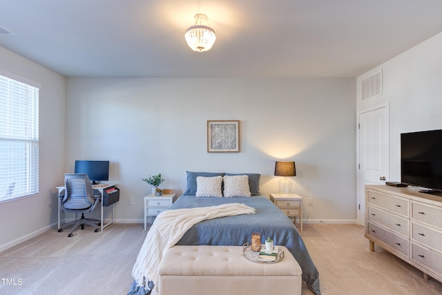 bedroom featuring light carpet, baseboards, and visible vents