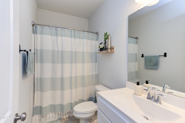 bathroom with toilet, curtained shower, and vanity