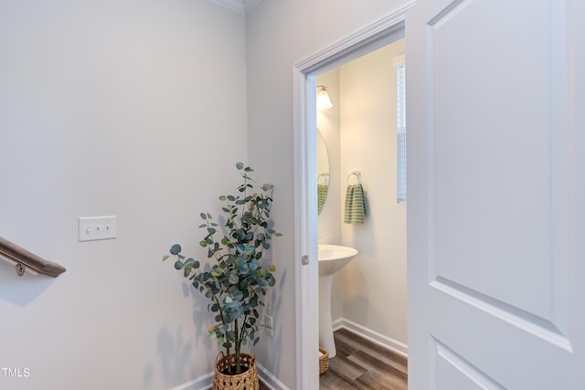 bathroom with baseboards and wood finished floors