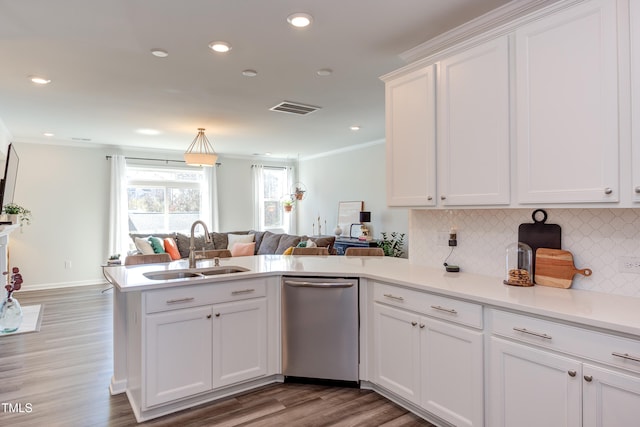 kitchen with visible vents, open floor plan, light countertops, white cabinetry, and a sink