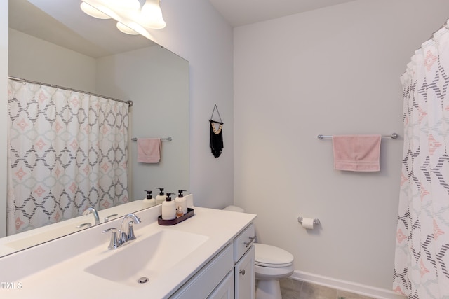 full bathroom featuring toilet, tile patterned floors, baseboards, and vanity