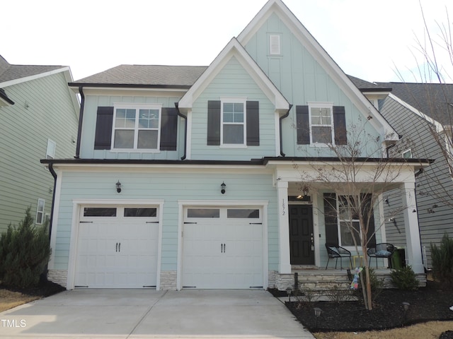 view of front of house with board and batten siding, a porch, a garage, stone siding, and driveway