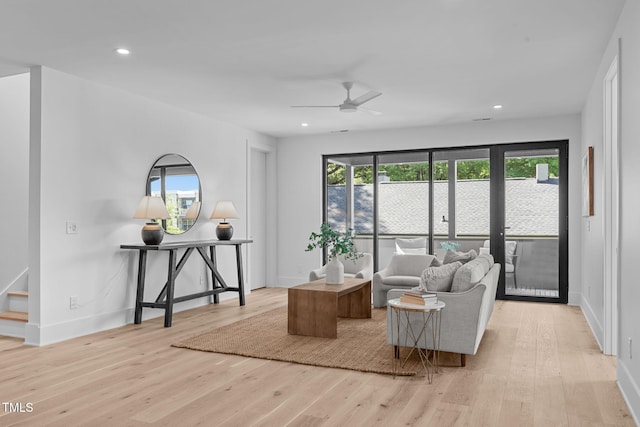 interior space with light wood finished floors, baseboards, stairway, and recessed lighting