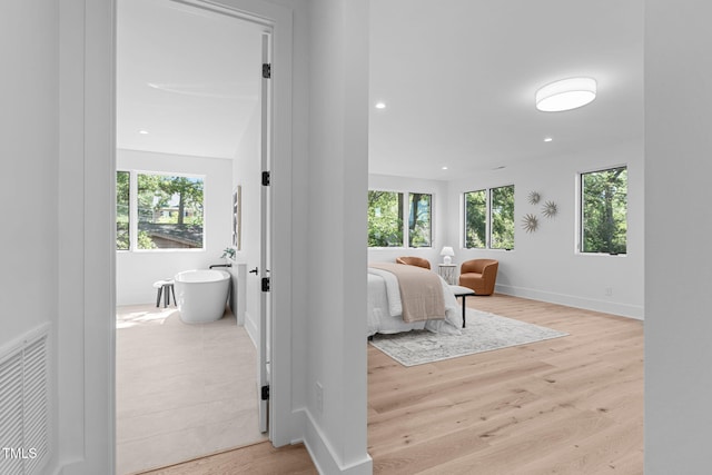 interior space featuring recessed lighting, light wood-type flooring, visible vents, and a healthy amount of sunlight