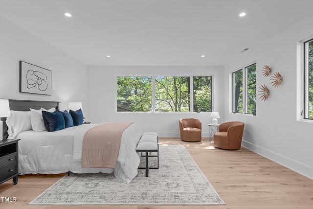 bedroom with baseboards, light wood-style flooring, and recessed lighting