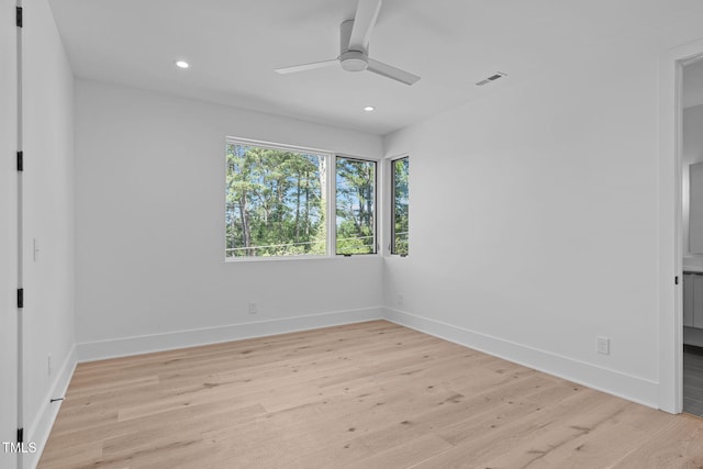 unfurnished room with light wood-type flooring, baseboards, and visible vents