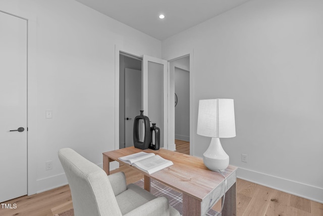 home office with recessed lighting, light wood-style flooring, and baseboards