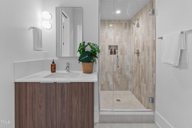 bathroom with a stall shower and vanity