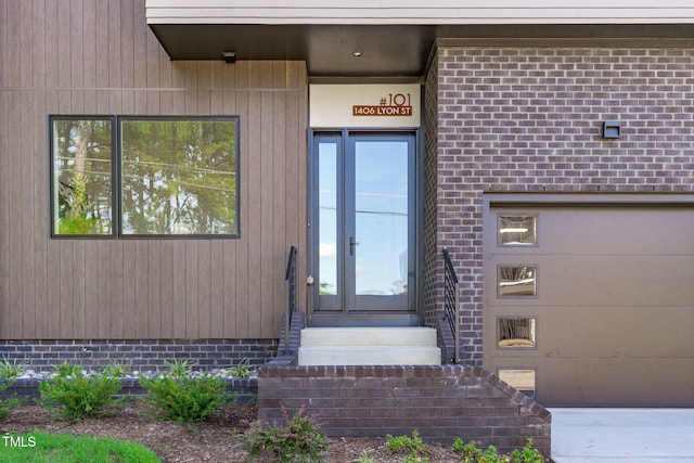 property entrance featuring an attached garage