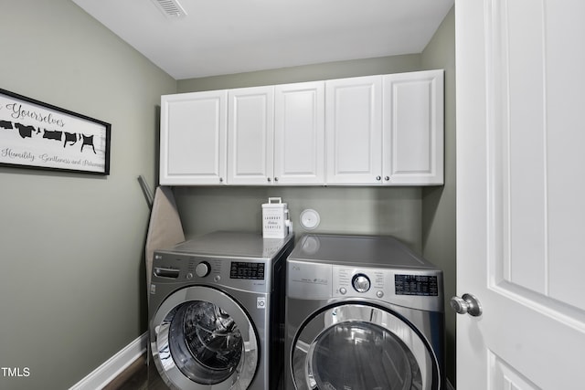 laundry room featuring cabinet space, baseboards, visible vents, and separate washer and dryer