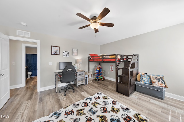 bedroom featuring light wood-style flooring, visible vents, and baseboards