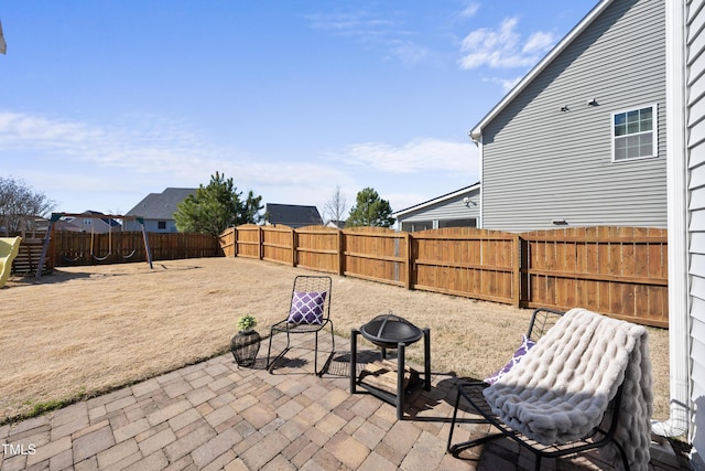 view of patio featuring a fenced backyard and a playground