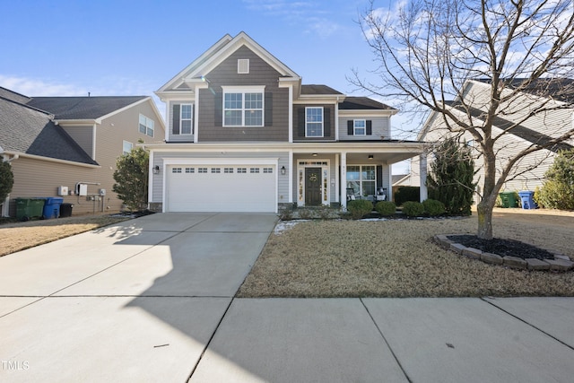 view of front of home with driveway, a porch, and an attached garage