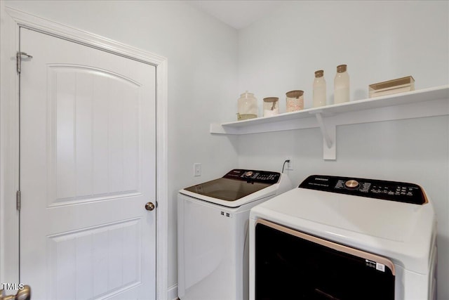 washroom featuring laundry area and washing machine and clothes dryer