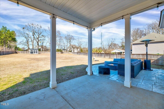 view of patio / terrace with a fenced backyard, a shed, an outdoor living space, and an outdoor structure