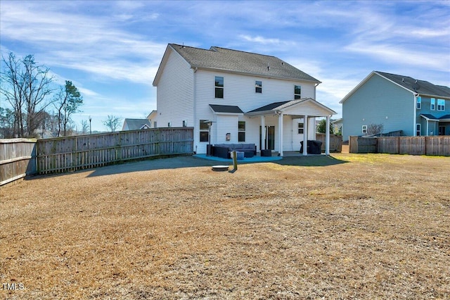 back of house with a yard, a patio area, and a fenced backyard