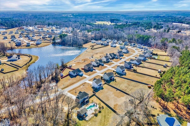 drone / aerial view with a water view and a residential view