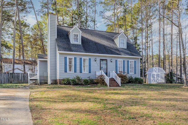 cape cod home featuring a storage shed, an outdoor structure, fence, a front lawn, and a chimney