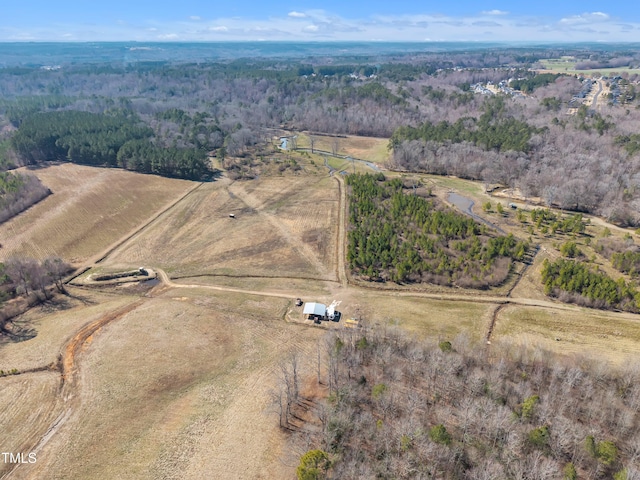 birds eye view of property with a rural view and a view of trees