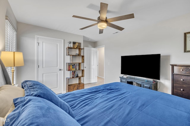 bedroom with ceiling fan, visible vents, and baseboards