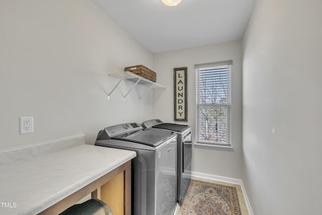 laundry room featuring baseboards, laundry area, and washer and dryer