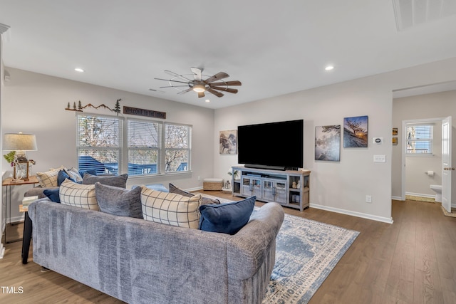 living area featuring ceiling fan, recessed lighting, wood finished floors, visible vents, and baseboards