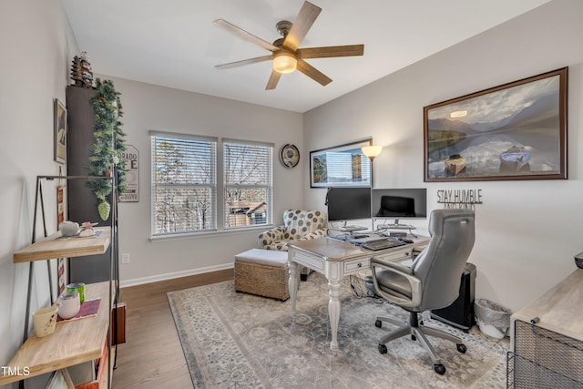 office area featuring a ceiling fan, baseboards, and wood finished floors