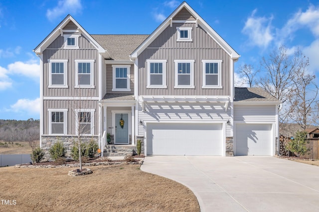 view of front of house featuring a garage, a shingled roof, stone siding, concrete driveway, and board and batten siding