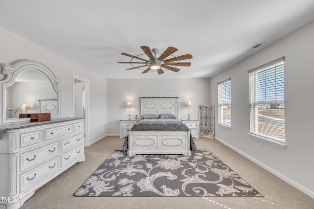 bedroom with visible vents, baseboards, a ceiling fan, and light colored carpet