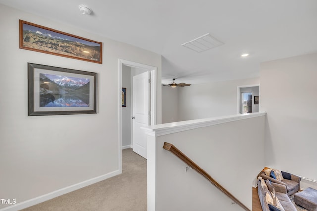 hall featuring visible vents, baseboards, an upstairs landing, carpet floors, and recessed lighting