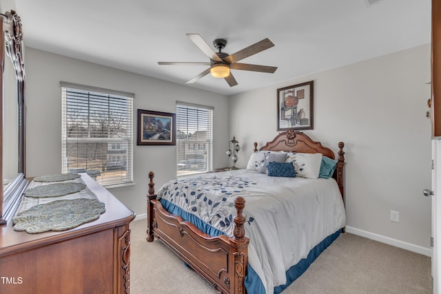 bedroom featuring light carpet, baseboards, and a ceiling fan