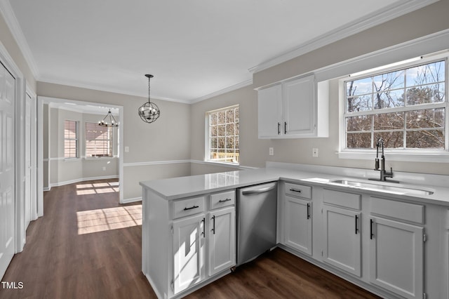 kitchen with light countertops, stainless steel dishwasher, white cabinetry, a sink, and a peninsula