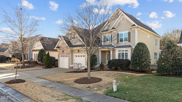 view of front of property featuring a garage, concrete driveway, and a front lawn