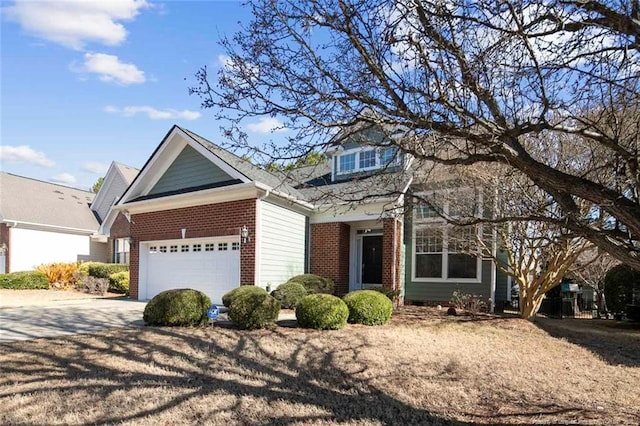 view of front facade featuring driveway, a garage, and brick siding