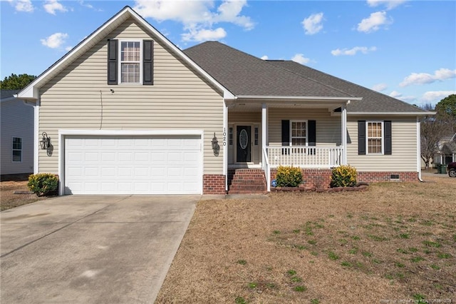 traditional-style home with roof with shingles, a porch, crawl space, a garage, and driveway