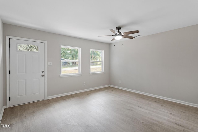 entrance foyer with light wood-style flooring, visible vents, baseboards, and a ceiling fan