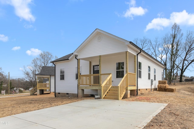 view of front of property with a porch, crawl space, and a shingled roof