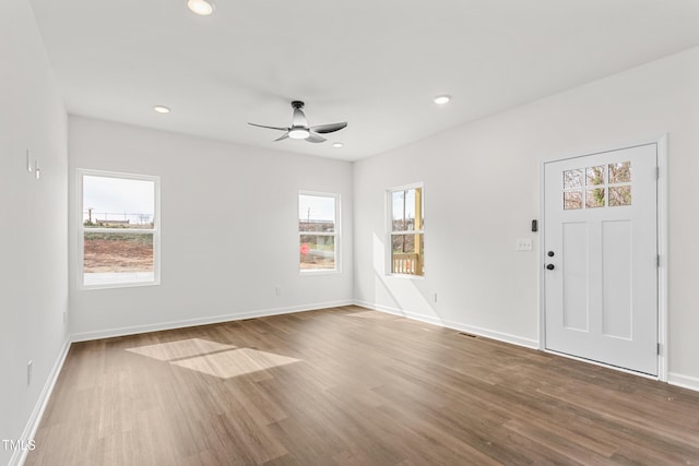 empty room featuring visible vents, baseboards, ceiling fan, wood finished floors, and recessed lighting