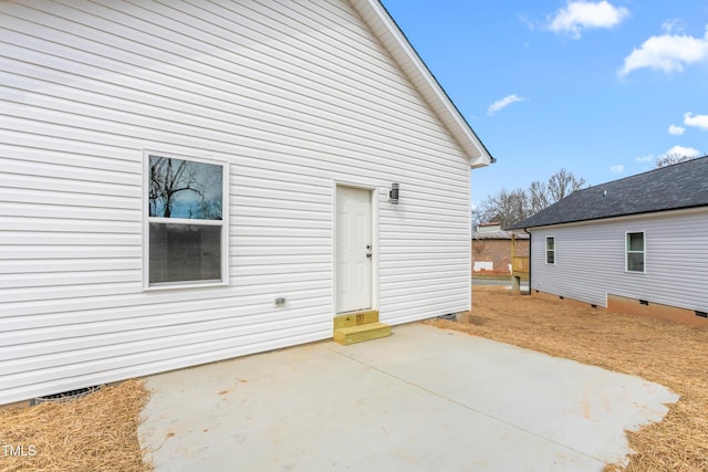 back of property featuring a patio and crawl space