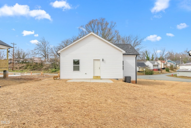 rear view of house with a patio area and central air condition unit