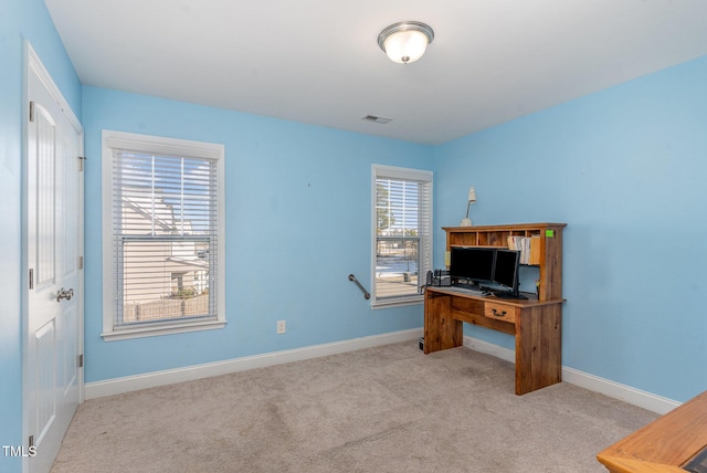 home office with baseboards, visible vents, and light colored carpet