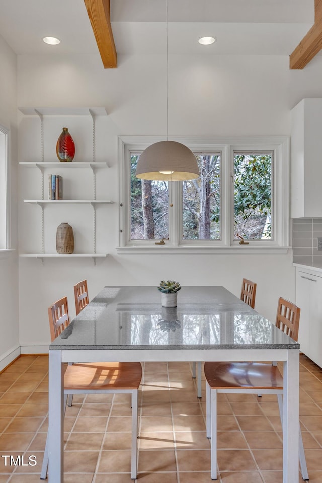 tiled dining area featuring beamed ceiling and recessed lighting