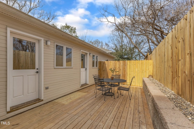 wooden deck with fence private yard and outdoor dining area