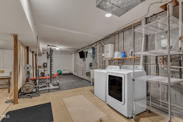 laundry area with laundry area, a textured ceiling, and washer and dryer