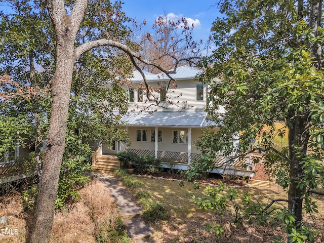 view of front facade with covered porch and metal roof